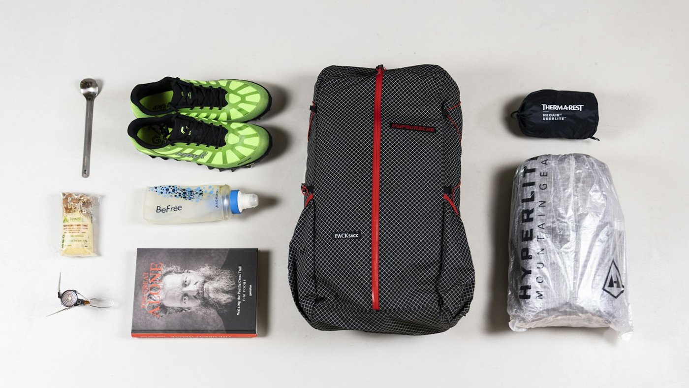 Lightweight hiking kit laid out on a plain surface for a budget gear check