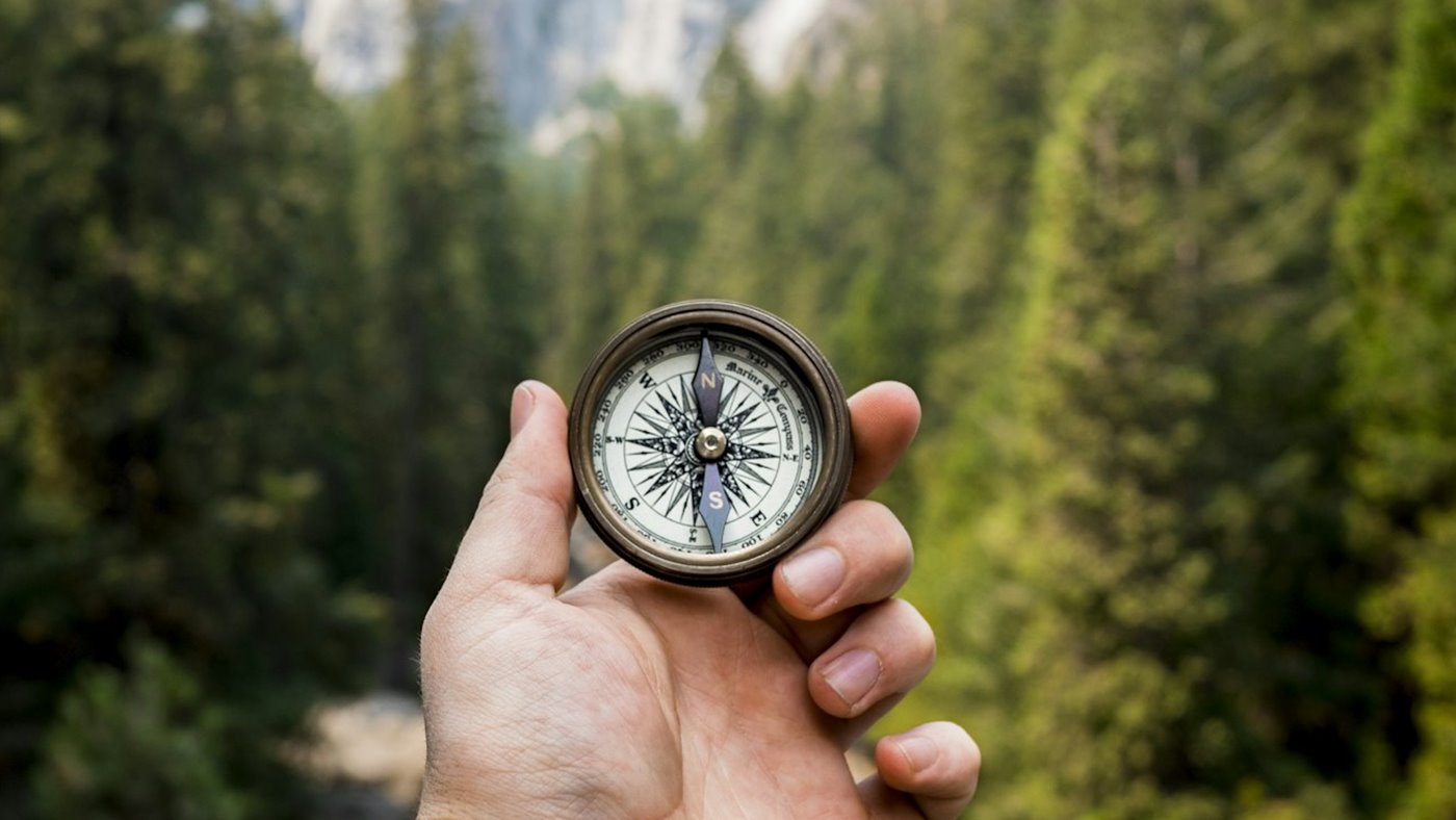 Compass held on trail as a backup to digital navigation
